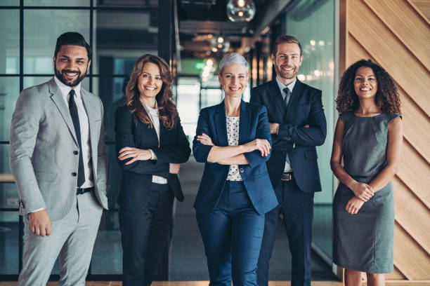 Multi-ethnic group of business persons standing side by side